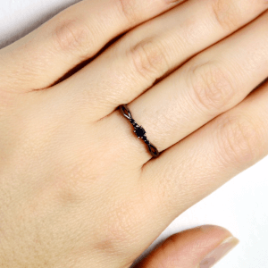drobny pierścionek z czarnego na dłoni